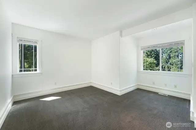 Second level bedroom #2 - several windows for natural light, ample space, and recently refreshed carpet.
