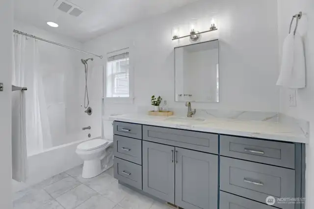 Second level full bath - New vanity with quartz slab countertops, new mirror and light fixture.
