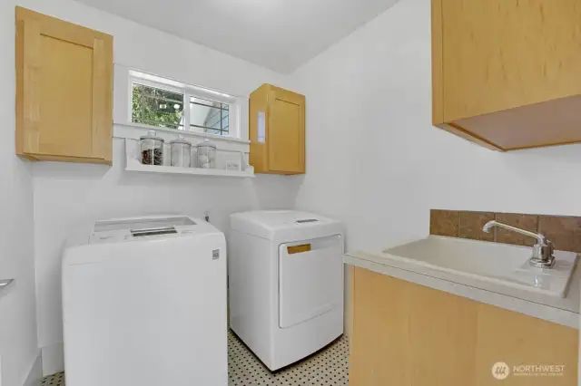 Second floor laundry room with utility sink.