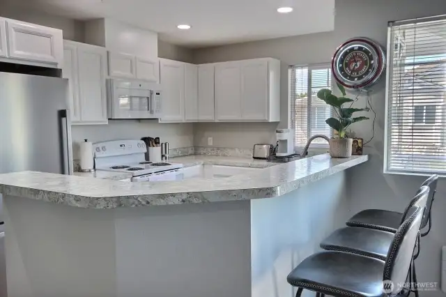 The kitchen has a dinette or service bar. Perfect for entertaining.