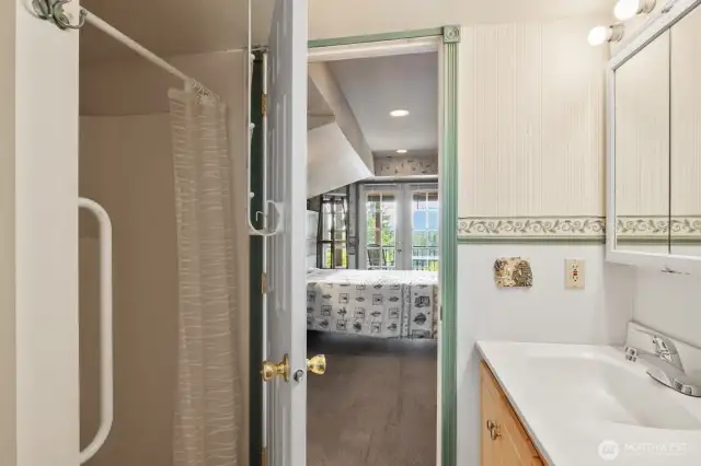 Bathroom in basement with shower, laundry, toilet and sink