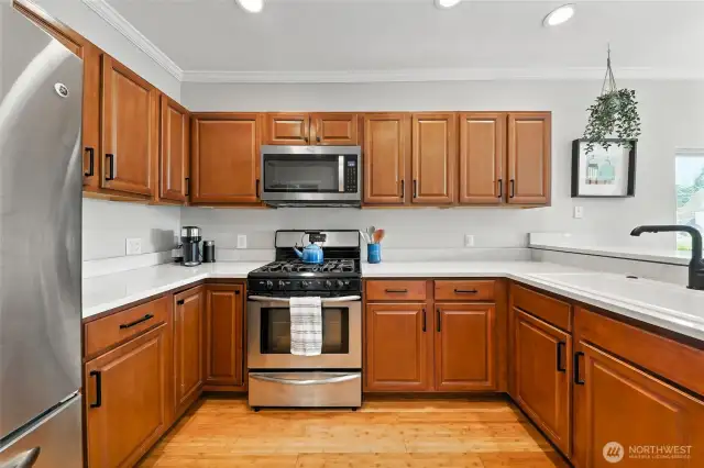 The fully remodeled kitchen features quartz counters, custom cabinets, stainless-steel appliances and cork floors.