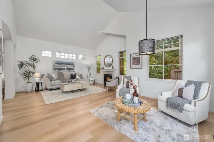 Living room with cozy gas fireplace, new flooring and formal dining or extra sitting space