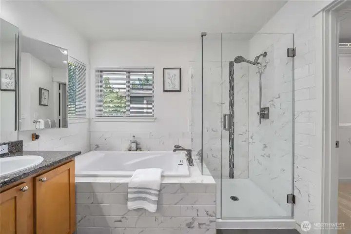 Primary suite with dual vanity, soaking tub, shower and walk-in closet