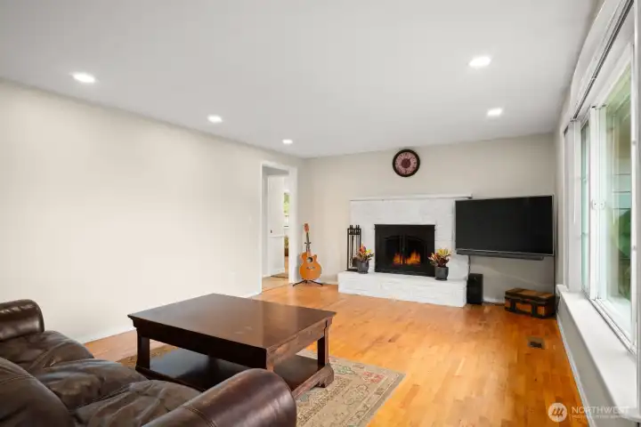 living room with recessed lighting, cozy wood fireplace