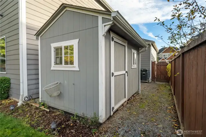 A well-kept detached shed offers extra storage for tools, yard gear, or seasonal items. Positioned conveniently off the side yard with easy access from the gate.