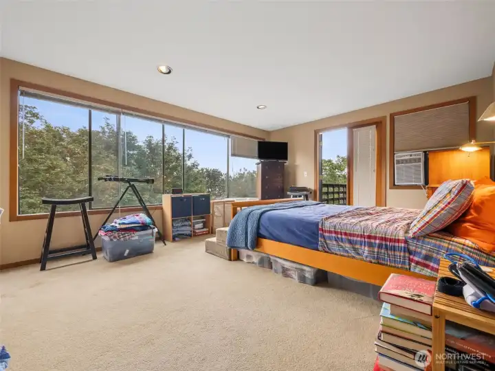 The primary suite with california closets and french doors leading to a private deck.