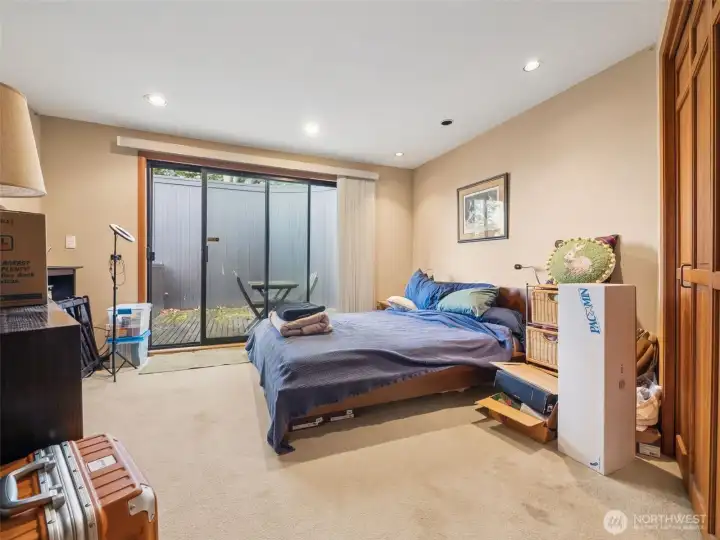 The second suite bedroom with french doors leading to a private deck