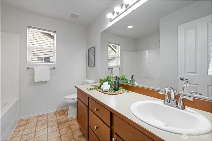 Second bathroom featuring double sinks and a window