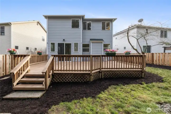 Large backyard deck ideal for gatherings and relaxation