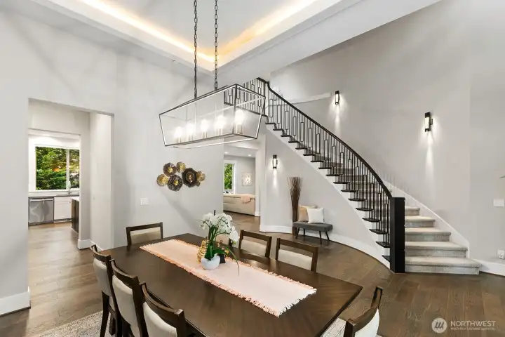 Formal dining room includes coved ceiling with accent lighting.