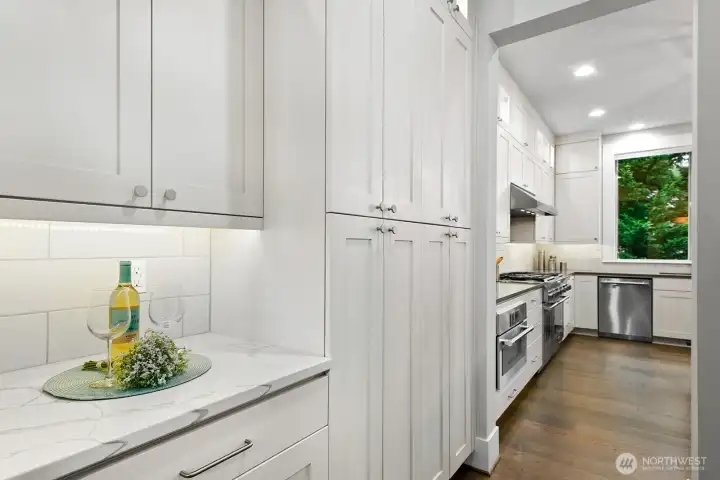 Butler's pantry with with Statuario Quartz countertop. Huge side by side storage cabinets.