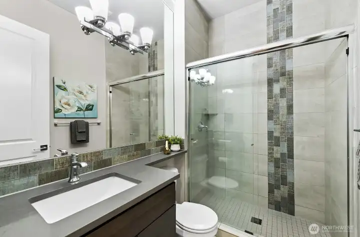 3/4 bath on the main level with custom tile work.