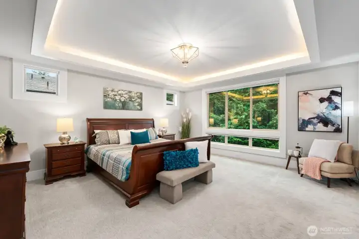 Spectacular primary bedroom suite with sitting area, luxurious bathroom and a custom walk-in closet.  Also features coved ceiling with accent lighting.