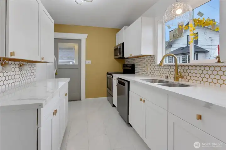 New kitchen with white cabinets and quartz counter tops