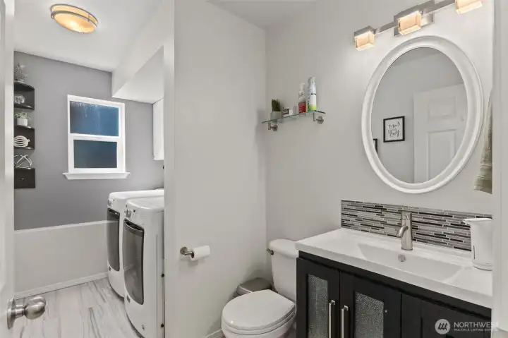 Lower level half bath and laundry room next to the family room.
