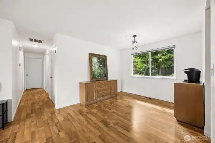 Dining space flows from living room. Hallway shown leads to three bedrooms and two bathrooms. One level living throughout.