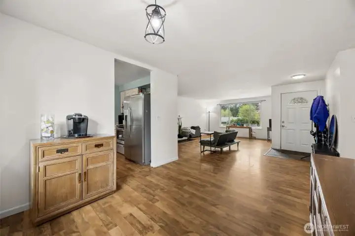 This view from the dining room shows the front door and a peek into the kitchen.