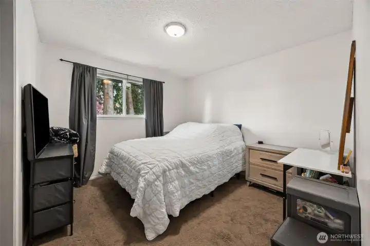 Second bedroom with window looking out over the front yard.