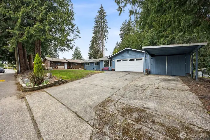 Tons of parking space! A two car garage, plus a two car enclosed carport, with extra carport in front of that. AND all the driveway parking you could need too!