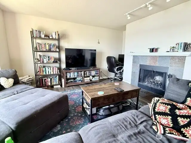 Large living room with wood burning fireplace and big windows that offer tons of natural light. Living room faces the water, so total no neighbors looking in!