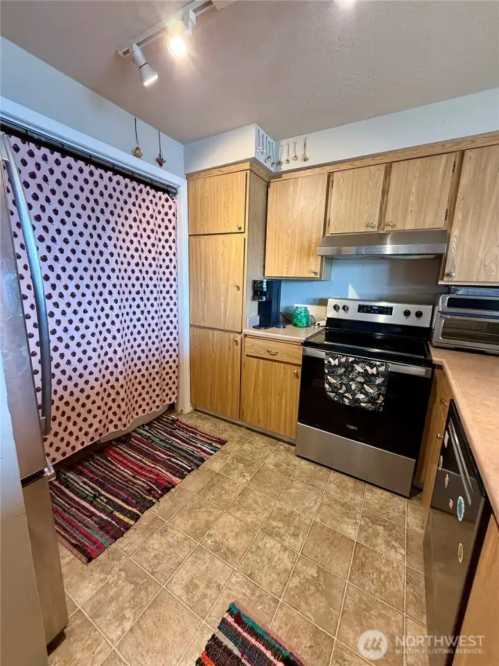Kitchen offers stainless steel appliances and newer cabinets.