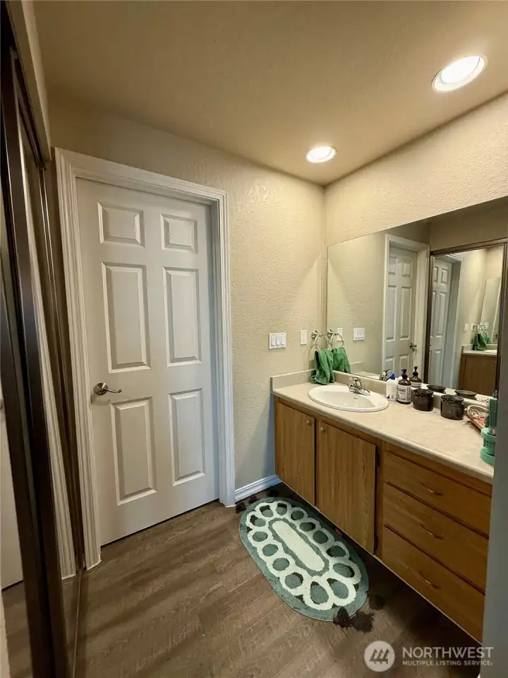 Primary bathroom, toilet tucked away.