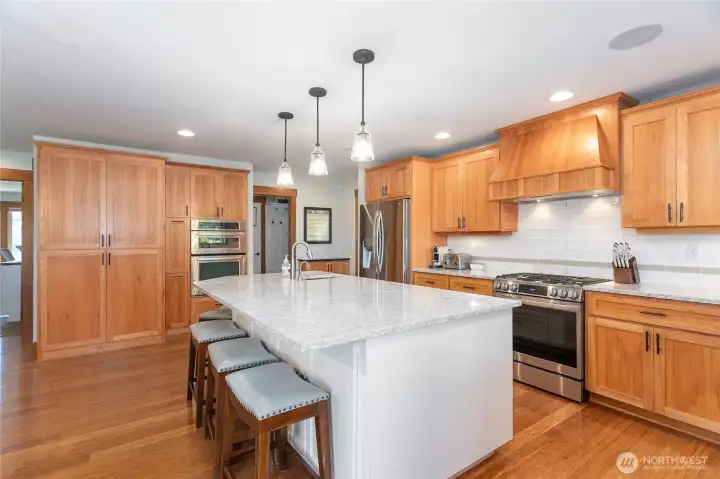 The countertops are quartz with tiled backsplash.
