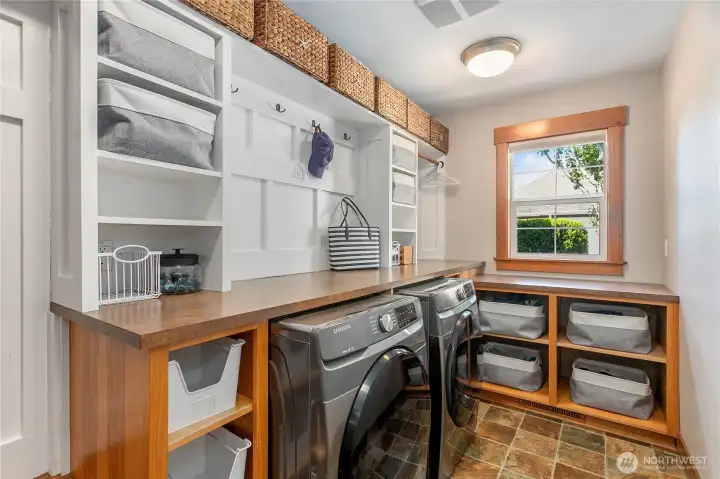The utility room is newly remodeled with plenty of work space and storage.
