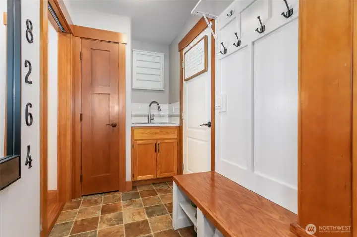 The utility room is conveniently located in-between the 3 car garage and the kitchen.