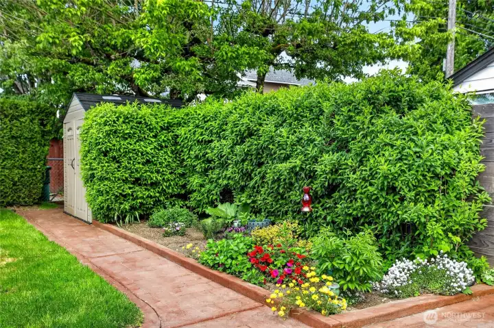 Fully fenced back yard, gate access to paved Alley, shed stays.
