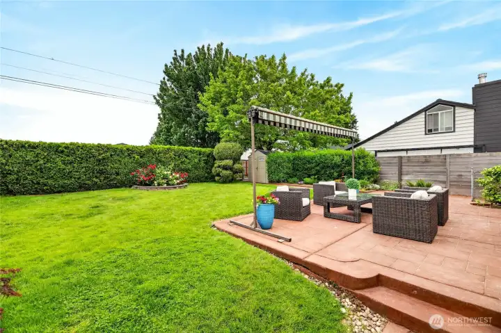 Fully fenced backyard, hedged for privacy.