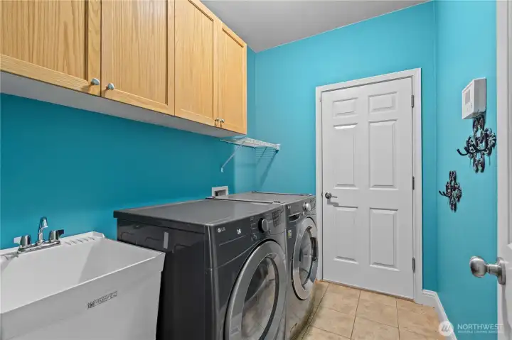 Conveniently located utility/laundry room featuring built-in upper shelving for excellent storage and organization-washer dryer stay Conveniently located utility/laundry room featuring built-in upper shelving for excellent storage and organization-washer dryer stay
