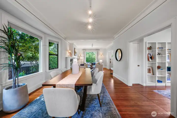 This bright dining area is surrounded by expansive windows and offers seamless, convenient access to the kitchen just steps away.