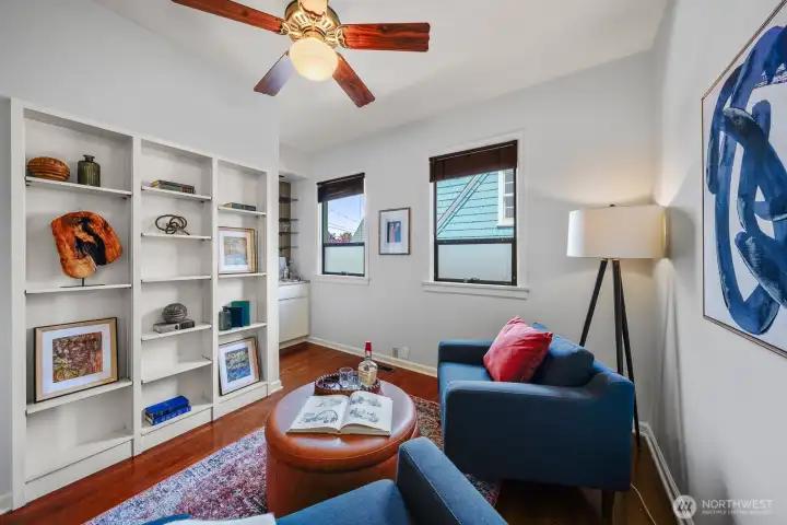 With a nod to the  turn-of-the-century, this den is highlighted by built-ins cabinets, a wet bar, and a convenient half-bath, just steps from the dining room.