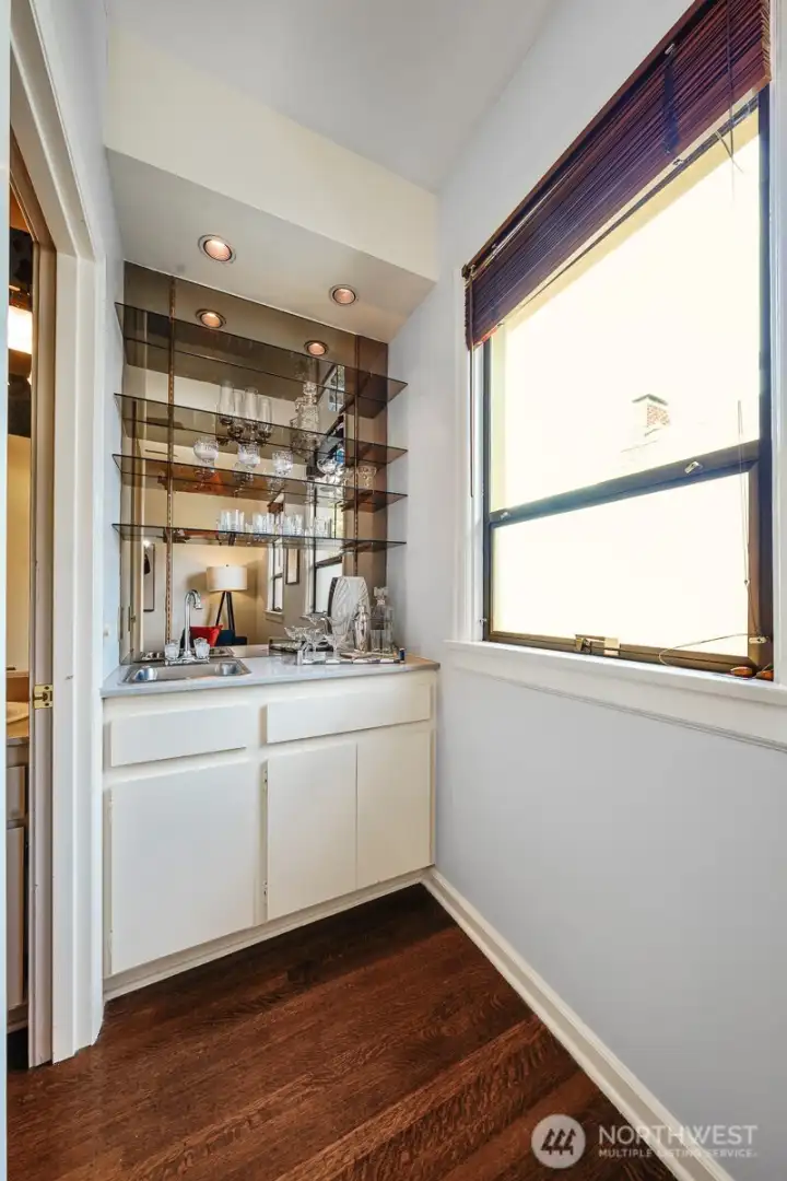 This home features a custom-designed mirrored wet bar that serves as the perfect feature for entertaining guests.