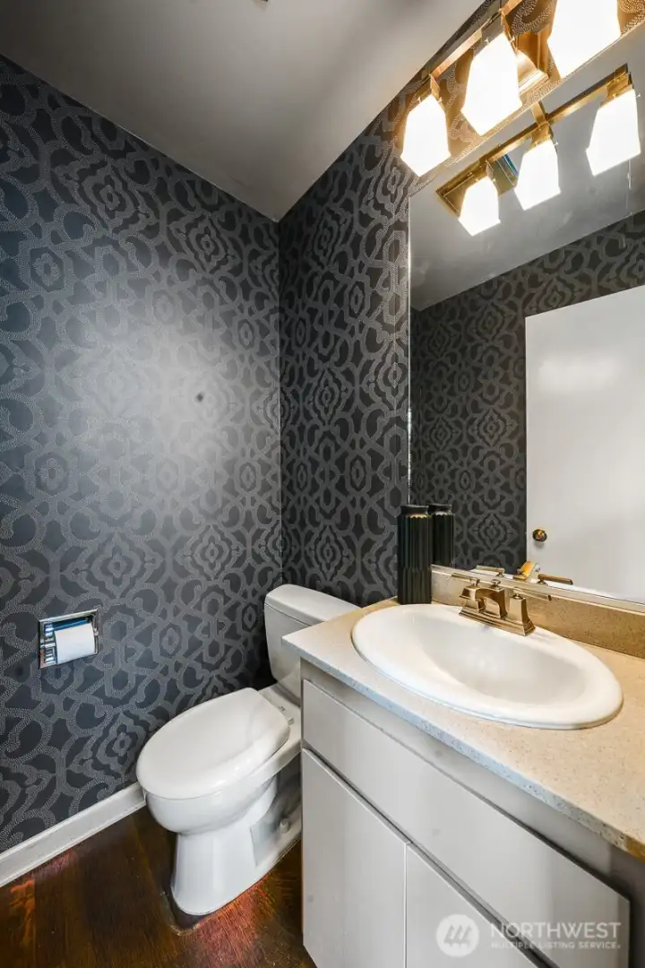 Elegant wallpaper in the main floor powder room adds a sophisticated finishing touch.