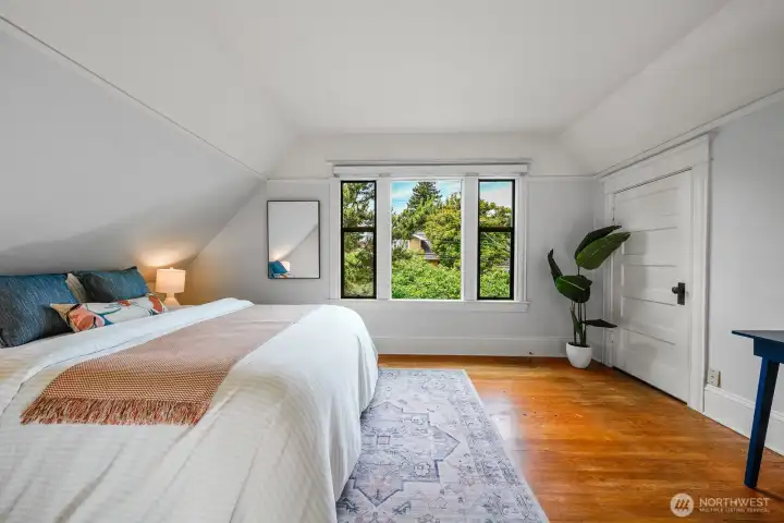 This is one of the three upstairs bedrooms, featuring a spacious walk-in closet and scenic winter views of the Cascade Mountains.