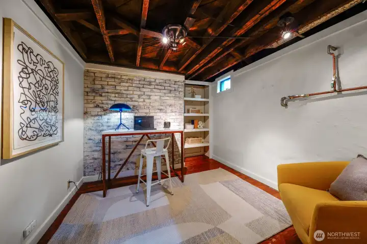 With beautifully exposed brick, this is just one small part of the   enormous daylight basement.  Perfect area for an office, craft room, yoga studio... you decide!