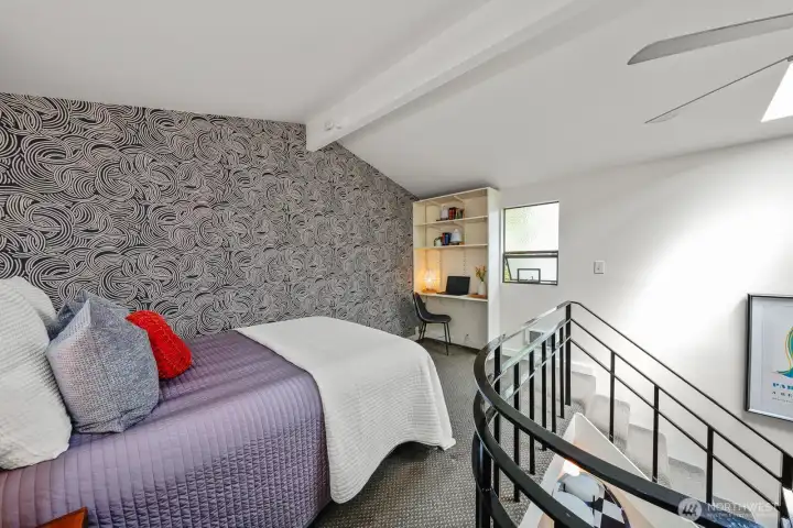 The upstairs bedroom features a  custom built-in cabinetry and a spacious closet.