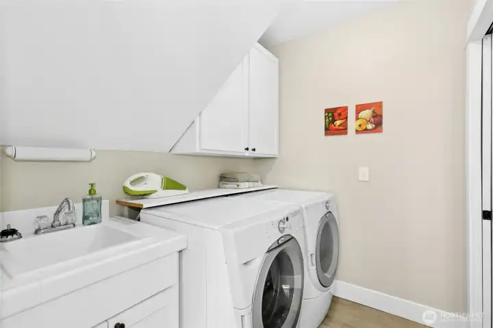The main-level laundry room keeps things easy when everyone returns from the beach covered in sand. Half bath out of view, to the right. The main-level laundry room keeps things easy when everyone returns from the beach covered in sand. Half bath out of view, to the right.