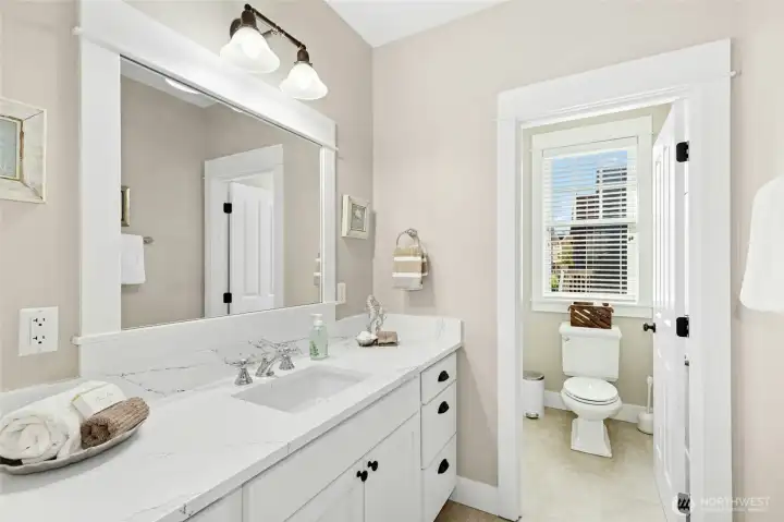 Bright and breezy second-floor bath with a shower/tub combo (out of view) - perfect after a day at the beach. Bright and breezy second-floor bath with a shower/tub combo (out of view) - perfect after a day at the beach.