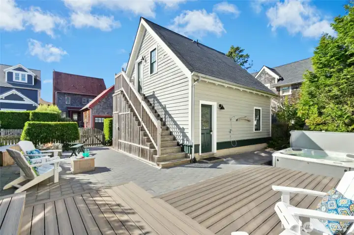 An outdoor shower at the back of the garage offers a convenient spot to rinse away the sand before stepping into the hot tub. Then climb the stairs to your carriage house for some quiet time. An outdoor shower at the back of the garage offers a convenient spot to rinse away the sand before stepping into the hot tub. Then climb the stairs to your carriage house for some quiet time.