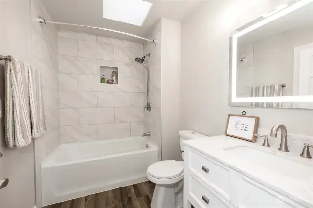 Primary en suite bath, recently updated with new tile surround, fixtures and vanity! Skylight brings in the natural light! The bathtub is a nice size for soaking, bring your bubbles and rubber ducky! The walk in closet is behind the camera.