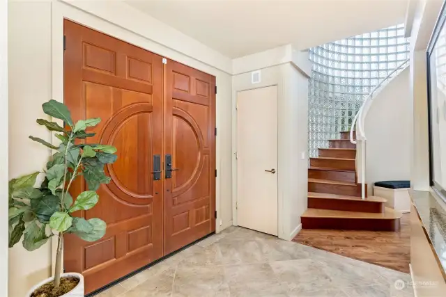 Grand Entrance with gorgeous winding staircase that is custom Brazilian cherrywood!