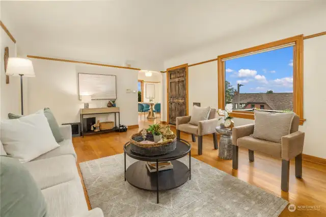 As you enter, you are greeted with ample light and spacious living room with views of the Cascades and Lake WA.