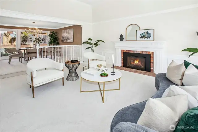 The formal living room features a vaulted ceiling with signature Buchan   crown molding & wainscotting