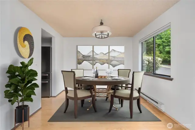 The dining area is accented with a window to let in the natural light. Virtually staged.