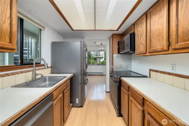 Well-appointed kitchen offers ample cabinetry and ample counter space.