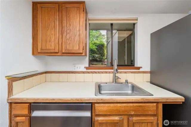 Enjoy the charm of a window above the kitchen sink, perfect for letting in light and fresh air.